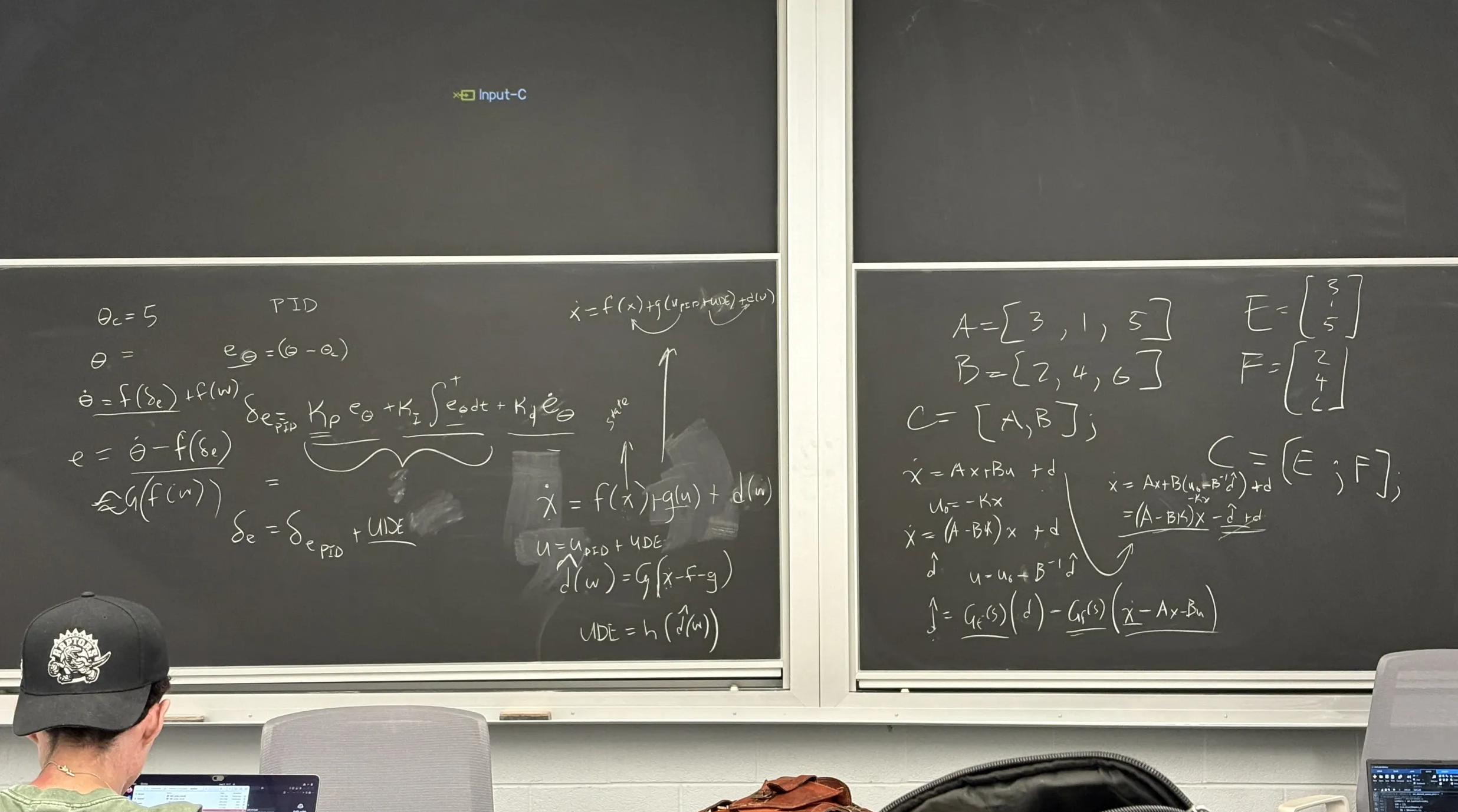 quadrotor trajectory-tracking research on a chalkboard at UTIAS