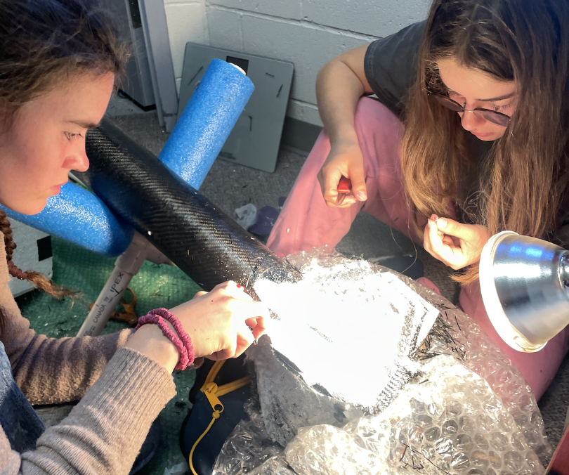 Team work continuing under a lamp